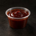 Rich smoky BBQ sauce in a 4 oz pot on a near-black background – Ben’s Fire & Feast