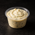 Homemade garlic mayo in a 4 oz pot on a near-black background – Ben’s Fire & Feast