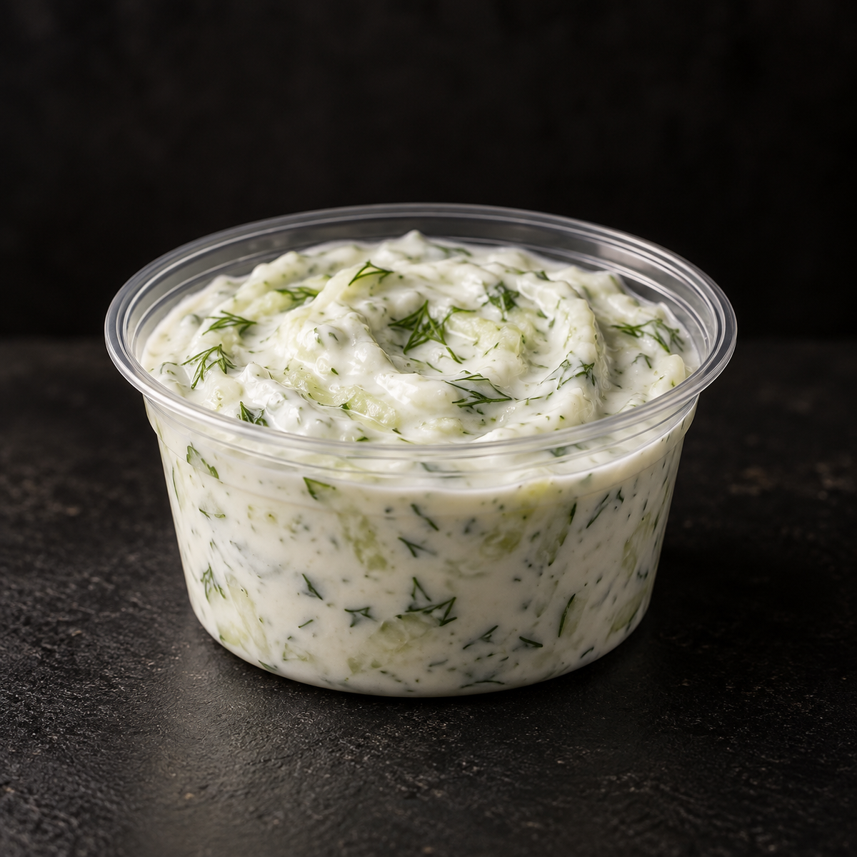 Fresh cucumber and herb tzatziki in a 4 oz pot on a near-black background – Ben’s Fire & Feast